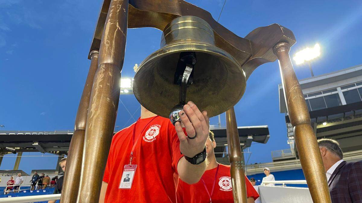 A Lexington Firefighter recruit rings a memorial bell in honor of a firefighter who died on 9/11.