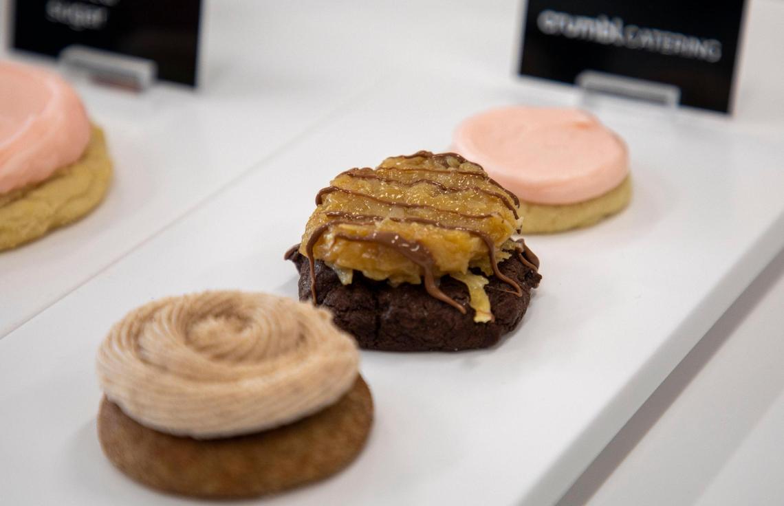 The cookie flavors Chilled Sugar, German Chocolate, and Churro are displayed by the register for customers to see at Crumbl Cookie’s Lexington location during the friends and family soft opening on Tuesday, May 18, 2021.
