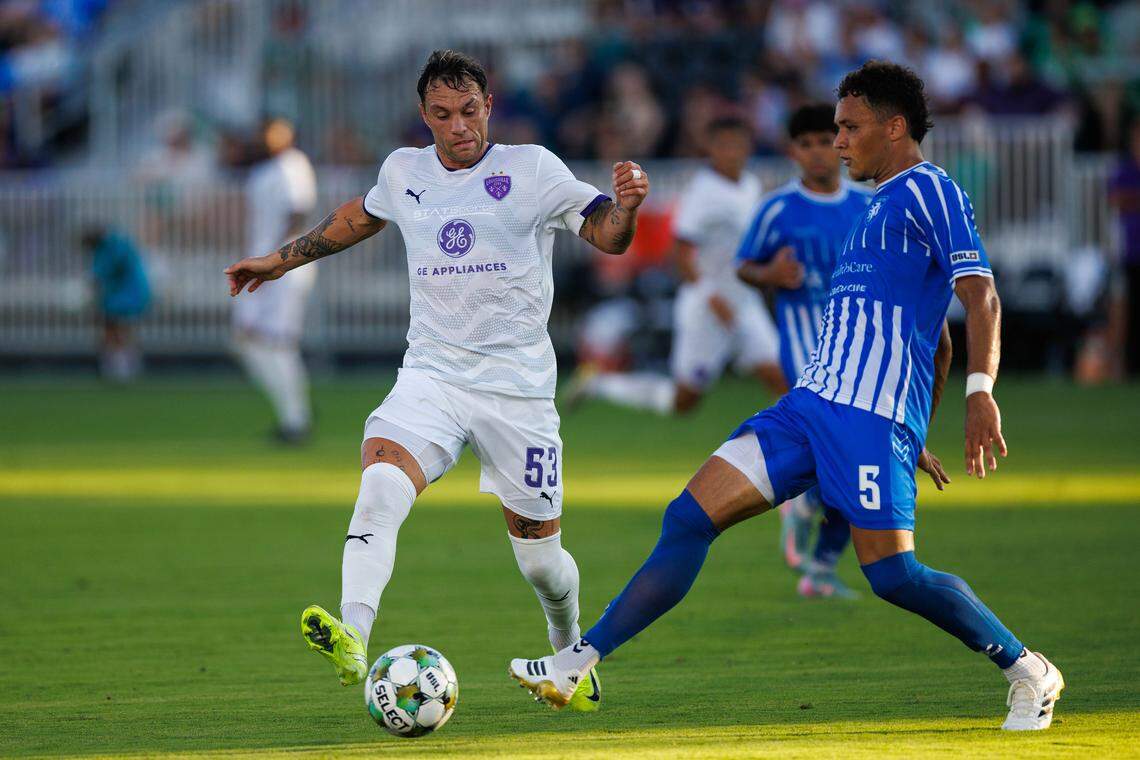 Louisville City’s Cameron Lancaster (53) tries to dribble the ball past Lexington Sporting Club’s Kendall Burks (5) during a match on Saturday, July 26, 2025, at the Lexington SC Stadium in Lexington.