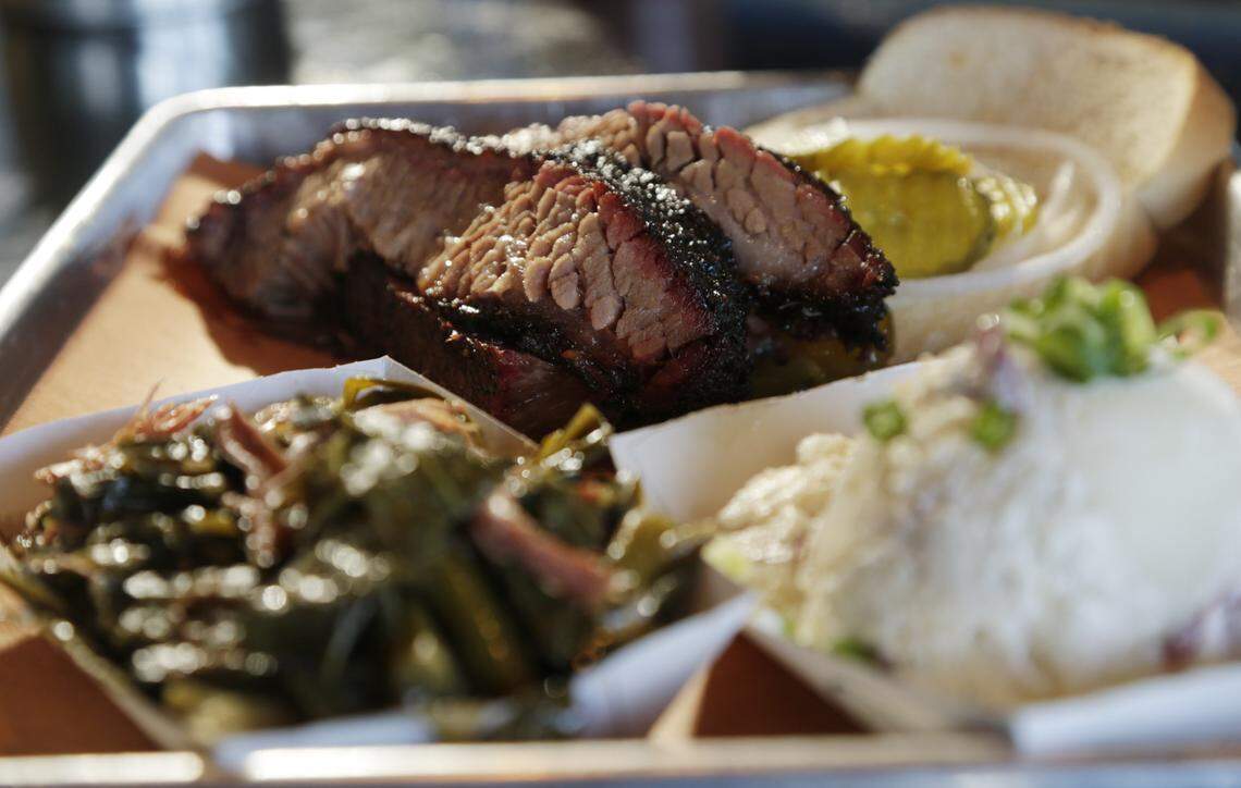 Brisket sandwich with collard greens and potato salad at the Blue Door Smokehouse.