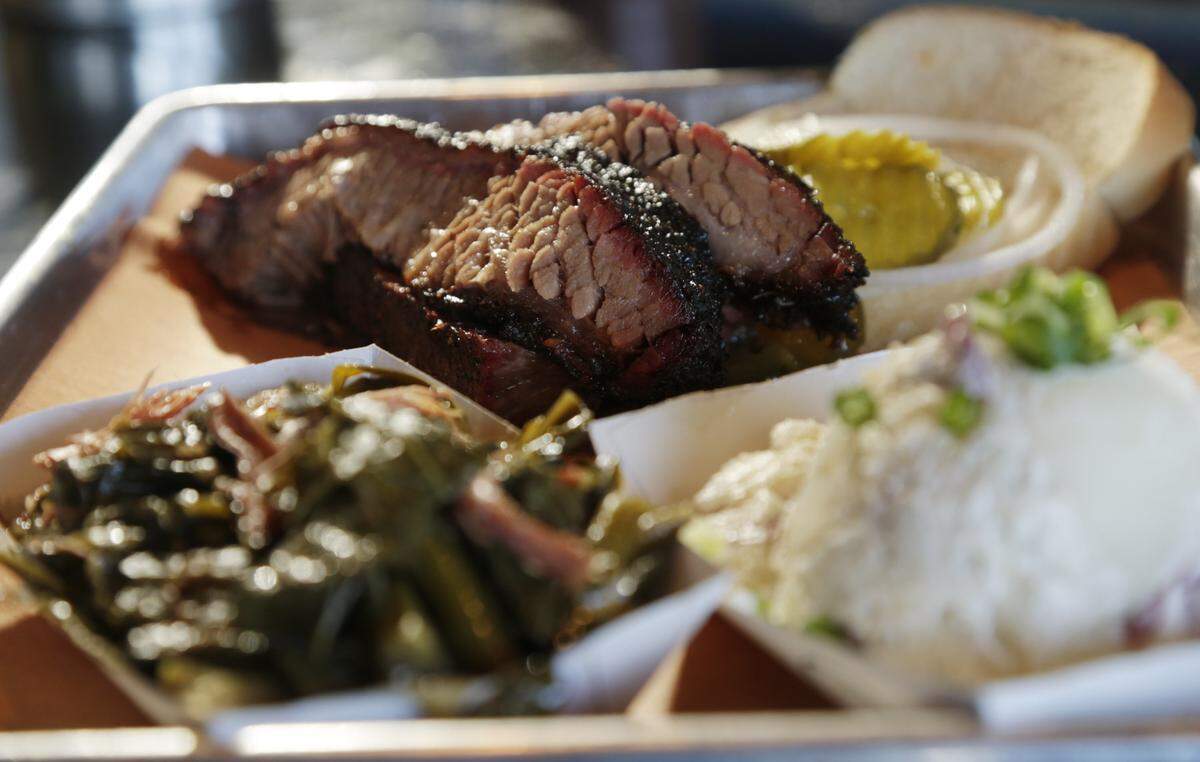 Brisket sandwich with collard greens and potato salad at the Blue Door Smokehouse.
