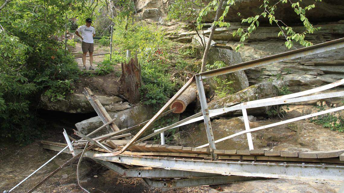 In July, Henry West of Versailles surveyed the damaged footbridge that crossed the top of Broke Leg Falls. Local lore says the creek and falls got their name because an ox broke its leg there.