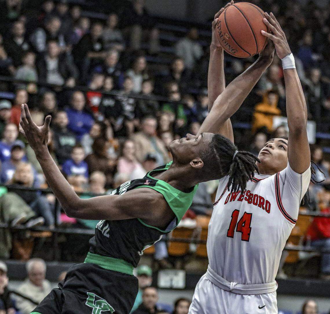 Owensboro Catholic’s Ji Webb (foreground) had 11 points and six rebounds in the Aces’ 56-45 upset of cross-town rival Owensboro in the 3rd Region championship game.