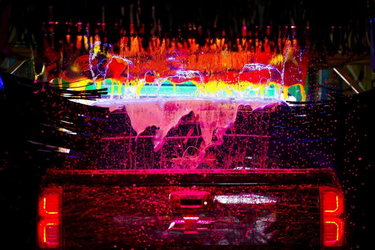 A Chevrolet truck passed through soapy water illuminated with LED lighting at Time to Shine car wash Wednesday in Lexington.