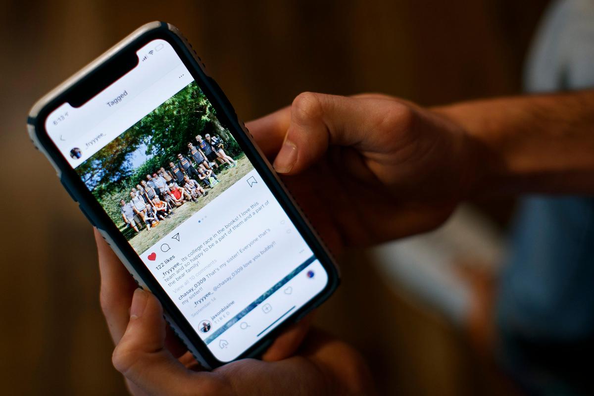 University of Pikeville cross country athlete Dalton Stiltner, of Pikeville, Ky., shows a picture of him with his team before a race earlier this month in Pikeville, Wednesday, Sept. 25, 2019. Stiltner, 21, suffered a collapse lung due to smoking a JUUL e-cigarette causing him to miss his last race.