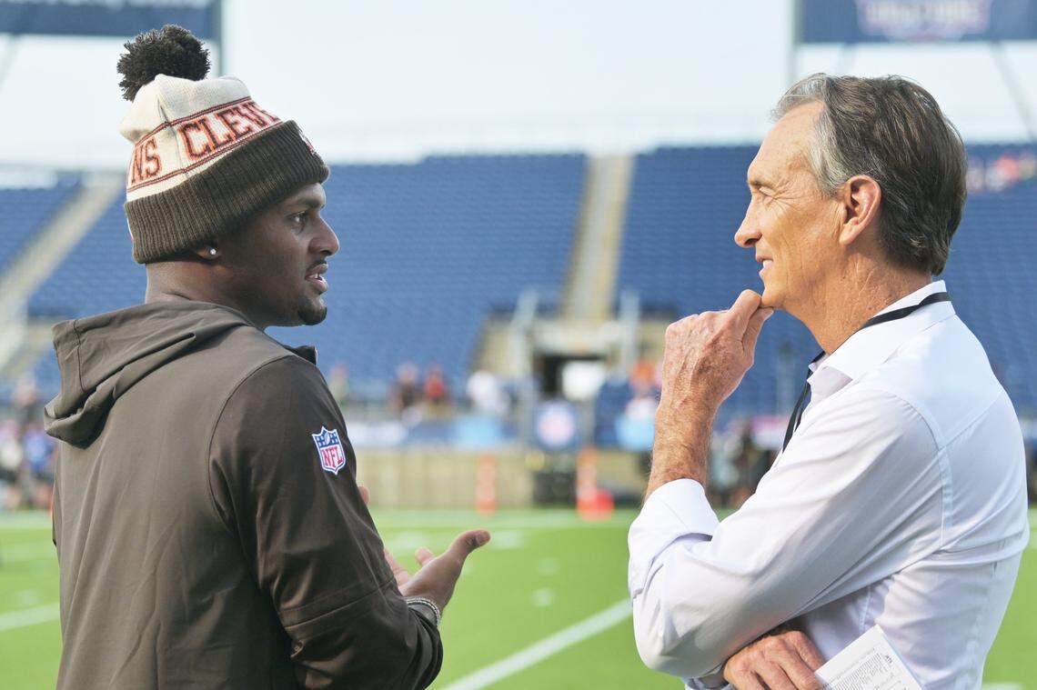 Cleveland Browns quarterback Deshaun Watson, left, talks to television personality and former NFL player Cris Collinsworth before the game between the Browns and the New York Jets at Tom Benson Hall of Fame Stadium on August 3, 2023.