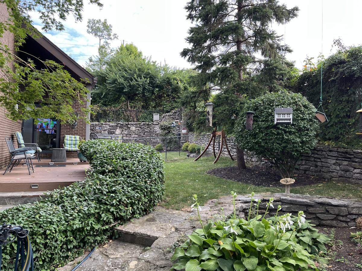 The stone boundary wall of Theresa Leito’s back yard would be torn down under eminent domain if the Fayette County schools prevail to make a wide road.