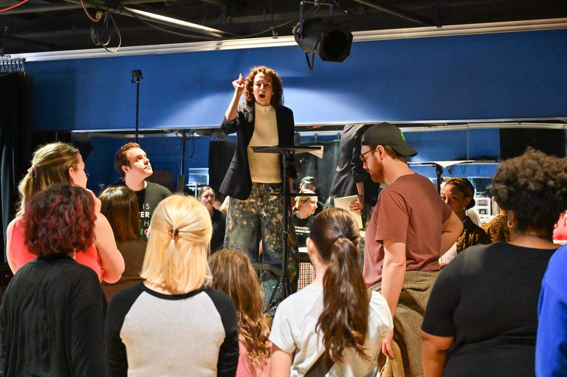 Stage director Sarah Ina Meyers talks to the cast of "A Nation of Others" during a rehearsal. The University of Kentucky Opera Theatre presents the world premiere of "A Nation of Others," an opera by Paul Moravec with a libretto by Mark Campbell. This photo was taken at a rehearsal February 28, 2026 in the Schmidt Vocal Arts Center on the University of Kentucky Campus in Lexington, Kentucky.