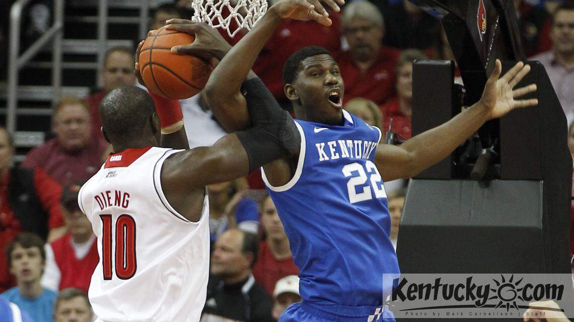 Kentucky Wildcats forward Alex Poythress (22) and Louisville Cardinals center Gorgui Dieng (10) got tangled up going for a rebound as Kentucky played Louisville on Saturday December 29, 2012 in Louisville, Ky. Photo by Mark  Cornelison | Staff 