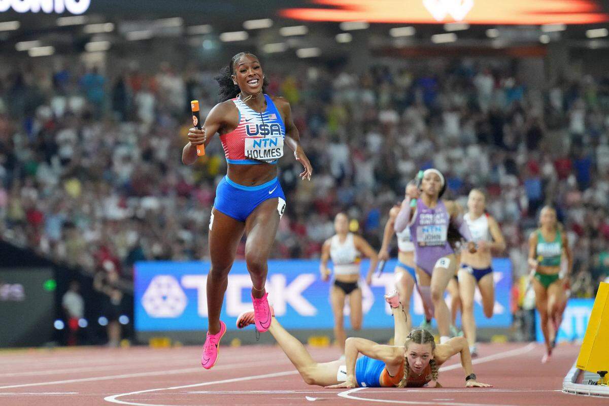 Aug 19, 2023; Budapest, Hungary; Femke Bol (NED) stumbles and falls as Alexis Holmes (USA) wins the 4x400m mixed relay with a time of 3:09.34 during the World Athletics Championships at National Athletics Centre. Mandatory Credit: Kirby Lee-USA TODAY Sports