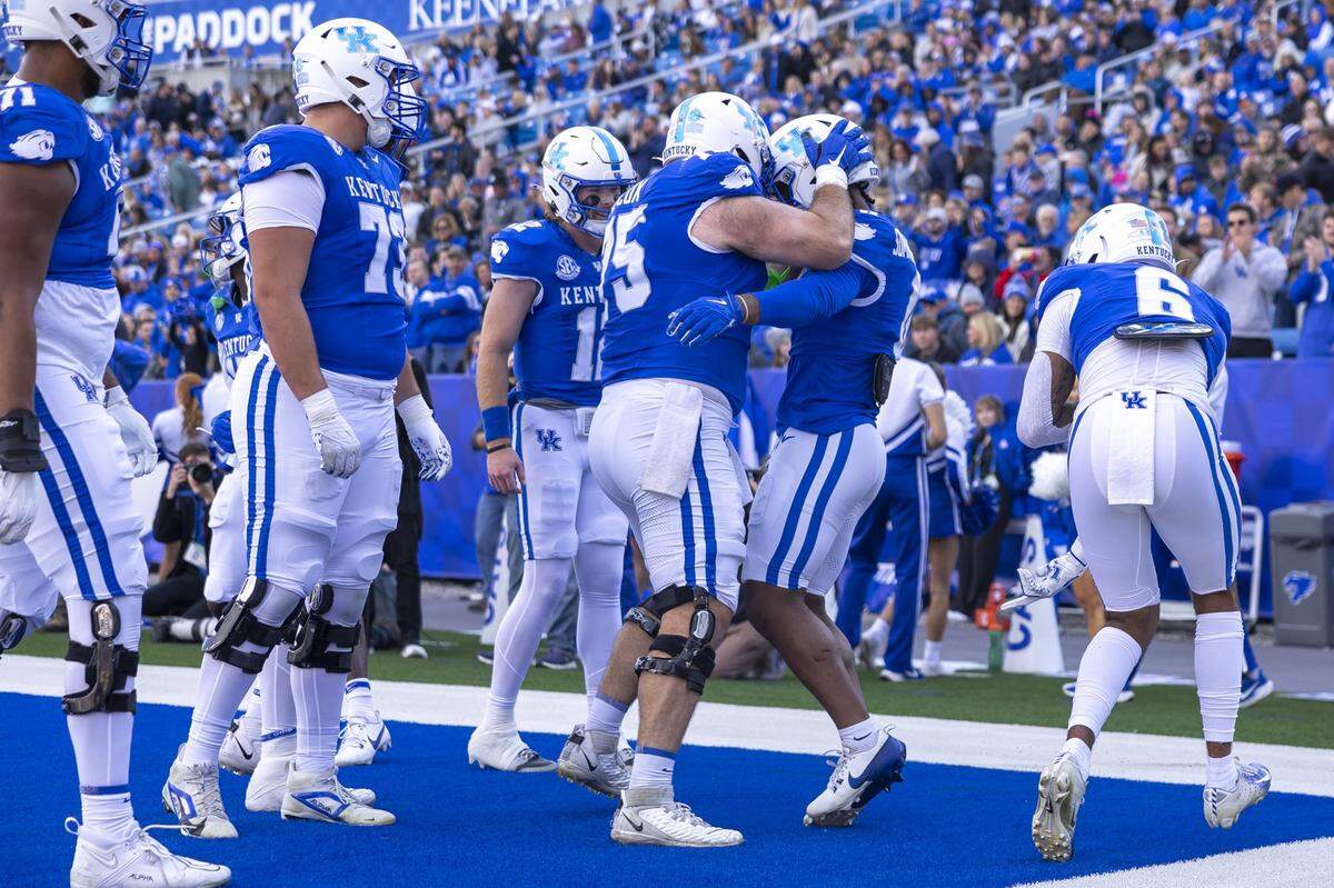 Kentucky running back Demie Sumo-Karngbaye, second from right, is congratulated by offensive lineman Eli Cox (75) after scoring a touchdown during Saturday’s win against Murray State at Kroger Field.