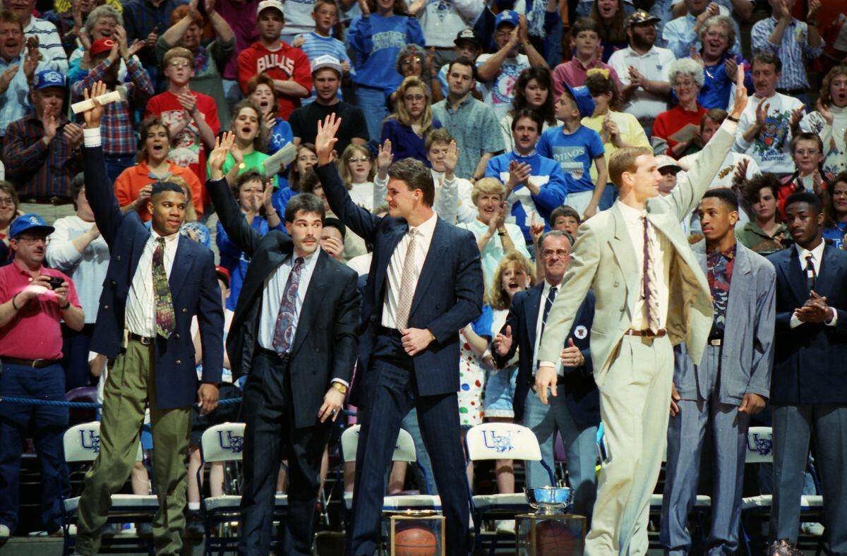 On April 7, 1992, University of Kentucky Athletics Director C.M. Newton surprised UK’s senior basketball players, from left, Sean Woods, Richie Farmer, Deron Feldhaus and John Pelphrey, by retiring their jerseys in Rupp Arena.