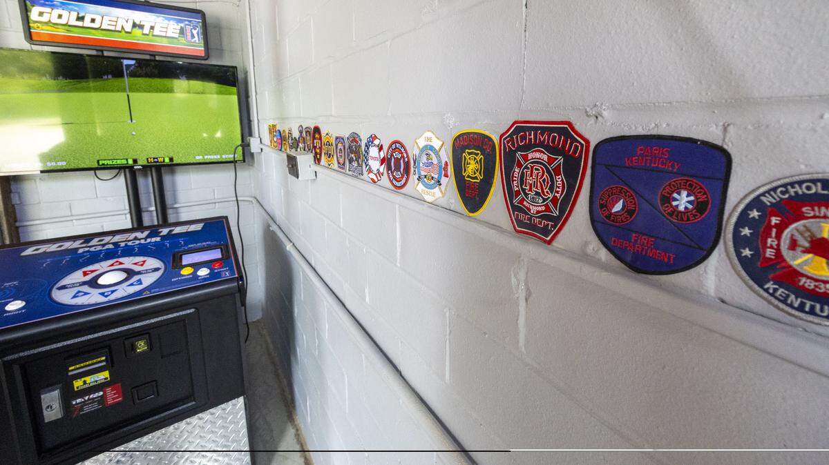 The Bruen Bunker’s decor includes honoring its history as a former fire station. Its walls are covered with fire-related history, including Central Kentucky patches and fire jackets. 