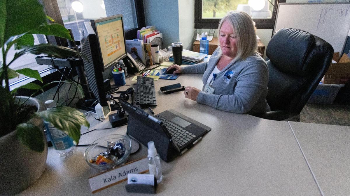 Kala Adms, infectious disease and preparedness manager at Lexington-Fayette County Health Department, sets up for a morning Zoom meeting at her desk in the Lexington-Fayette County Health Department on Newtown Pike, September 13, 2021. Kala leads all Epidemiologist within the health department, who have had their work shift 100% to investigating hundreds of COVID-19 positive cases in Fayette County that come in every day.