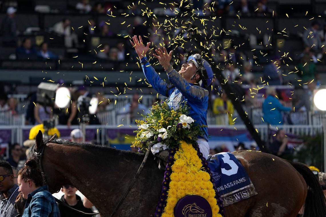 Junior Alvarado celebrates atop Cody’s Wish after winning the Breeders’ Cup Dirt Mile horse race Saturday, Nov. 4, 2023, at Santa Anita Park in Arcadia, Calif. (AP Photo/Mark J. Terrill)