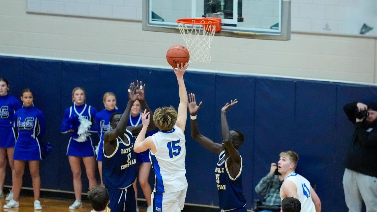 Lexington Catholic’s Jacob Holland (15) floated a game-winning shot over Danville Christian’s Leek Ateny, left, and Lual Ayei to help the host Knights beat the No. 9 Warriors 55-54 on Tuesday.
