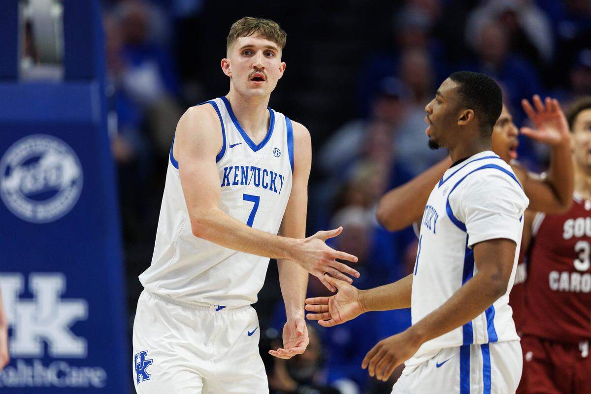 Feb 8, 2025; Lexington, Kentucky, USA; Kentucky Wildcats forward Andrew Carr (7) fives guard Lamont Butler (1) during the first half against the South Carolina Gamecocks at Rupp Arena at Central Bank Center. Mandatory Credit: Jordan Prather-Imagn Images