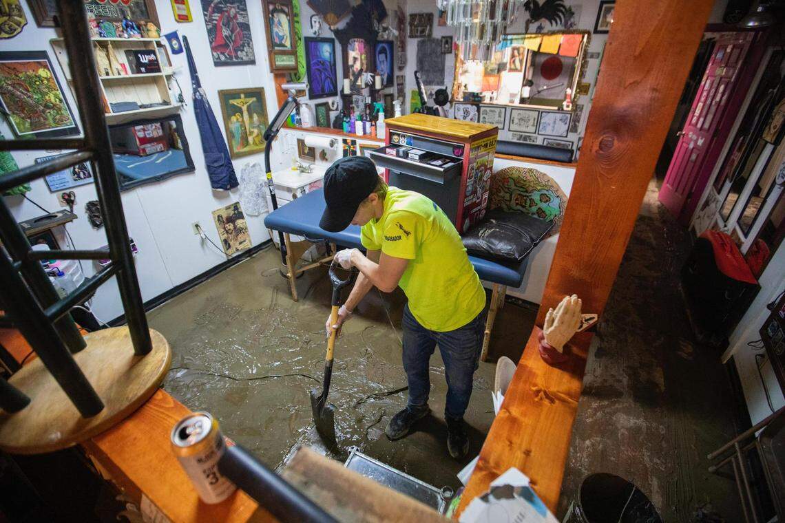 Austin Caudill works to clean out the Parlor Room Arts and Tattoo Shop in downtown Whitesburg, Ky., Friday, July 29, 2022.