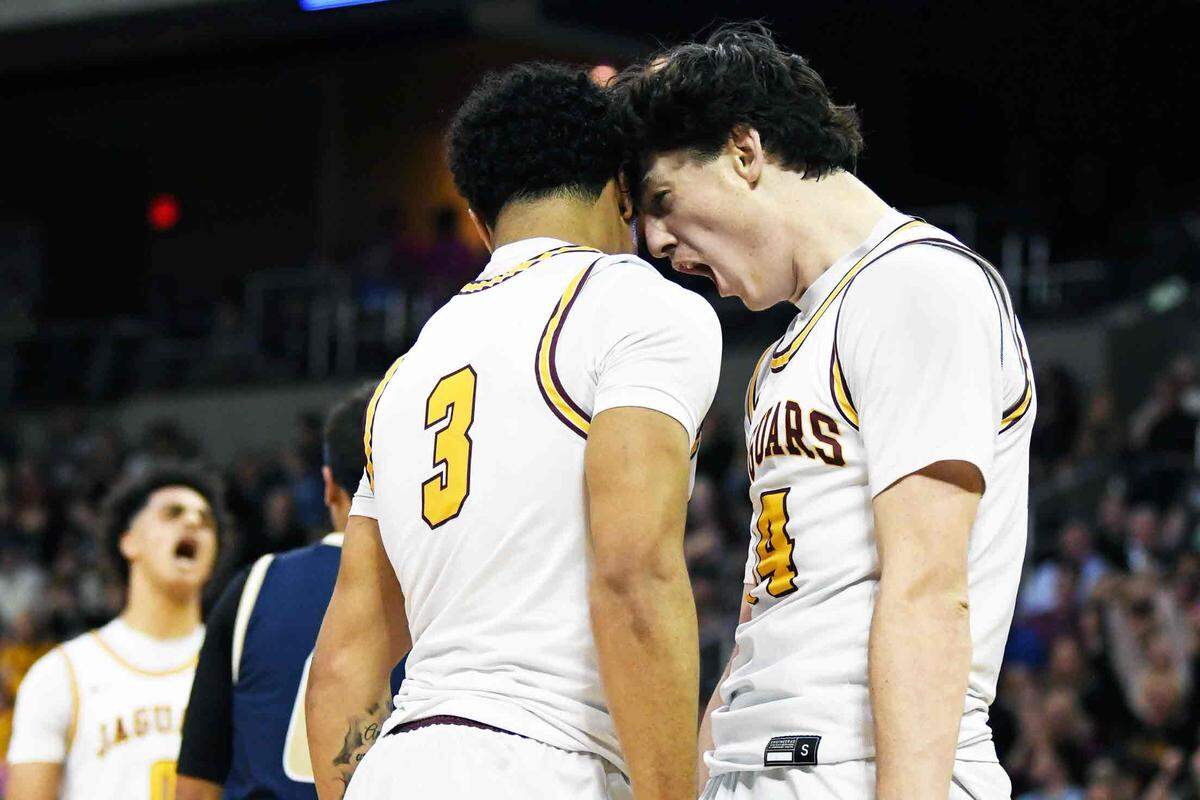 Cooper’s Andy Johnson, right, celebrated with fellow senior Jaidan Combs during last week’s Ninth Region Tournament title game.