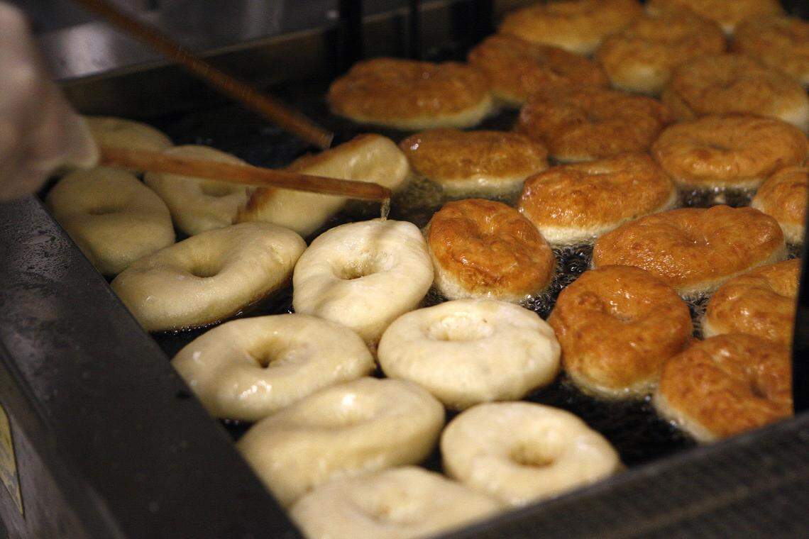 Eric Zarycki turns donuts in the fryer at Magee’s Bakery.