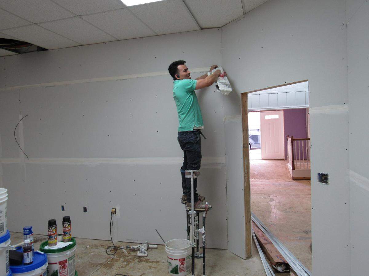 Elvin Lara works on repairing walls in a business in Beattyville, Ky., on March 25, 2021 following widespread flooding in town on March 1.