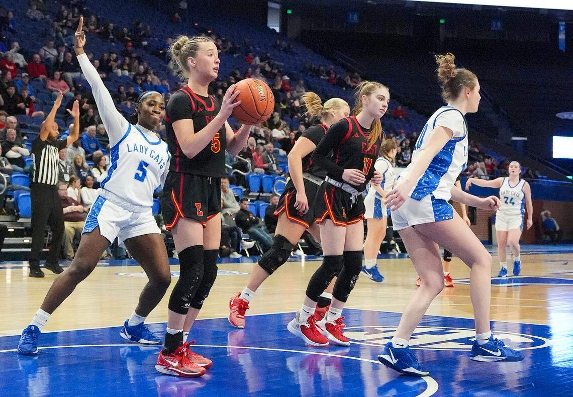 Franklin-Simpson's Tiffany Harrigan (5) raises three fingers to celebrate the long-range bucket by teammate Allye Pennington (24) as Bullitt East’s Anna Tinelli retrieves the ball during the Clark’s Pump-N-Shop Girls’ Basketball Sweet 16 first round at Rupp Arena on Thursday.
