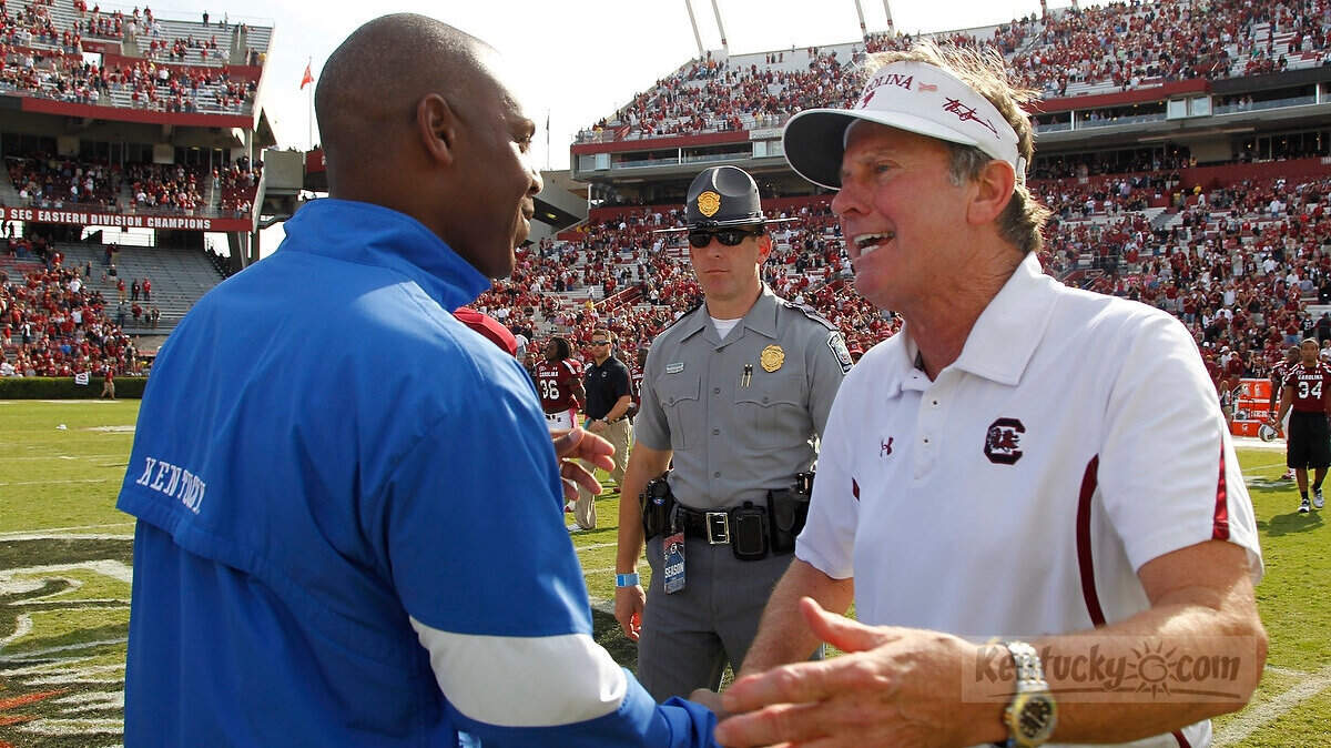 Head coaches Joker Phillips, left, and Steve Spurrier shook hands after Kentucky's 54-3 routing at South Carolina's Williams-Brice Stadium in Columbia, S.C., on Oct. 8, 2011.  Photo by Pablo Alcala | Staff