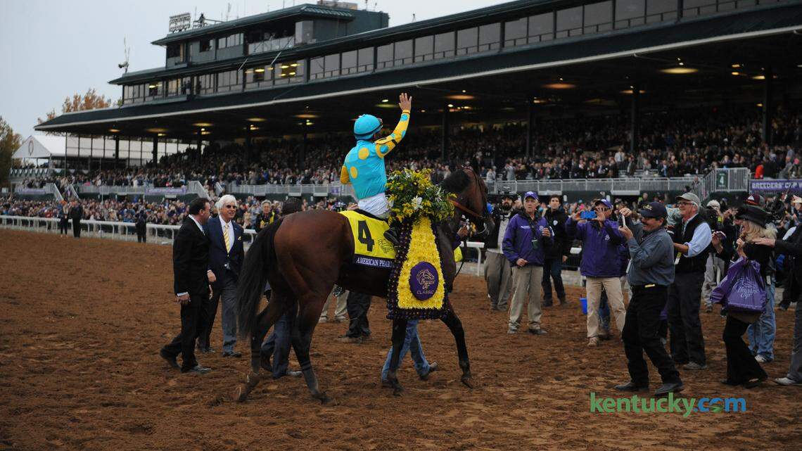 Jockey Victor Espinoza waves to the stands as he heads to the winner's circle aboard American Pharoah after capturing the Breeders' Cup Classic at Keeneland on Saturday, October 31, 2015. Photo by Ken Weaver