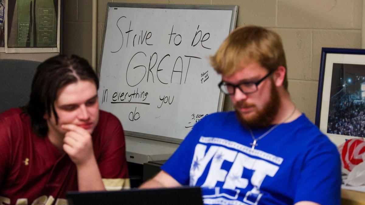 Kentucky Kernel Sports Editor Cole Parke, left, and Assistant Sports Editor Jonathon Bruner, right, talk during a staff meeting, Monday, March 10, 2025 in the offices of the independent student newspaper of the University of Kentucky in Lexington, Ky.
