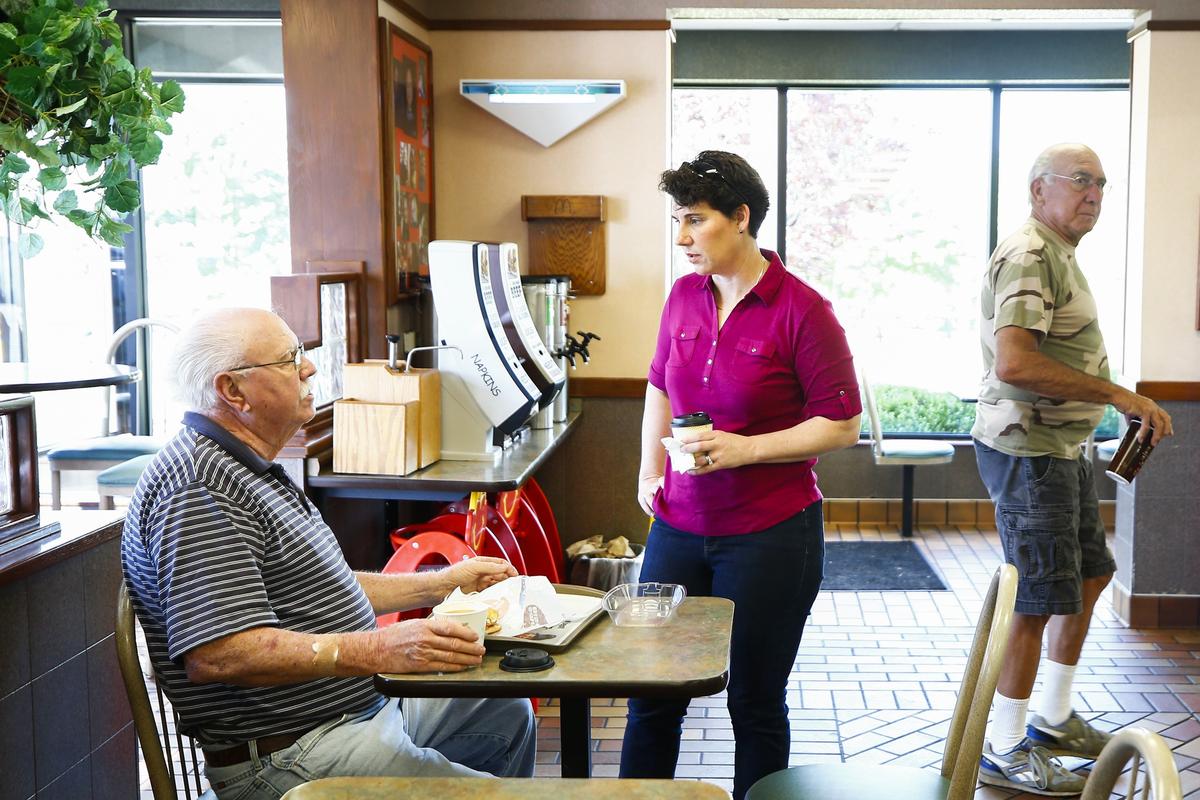 Chuck Roberts, of Versailles, left, spoke with Kentucky 6th Congressional District candidate Amy McGrath, center, at McDonalds while campaigning Monday in Versailles.