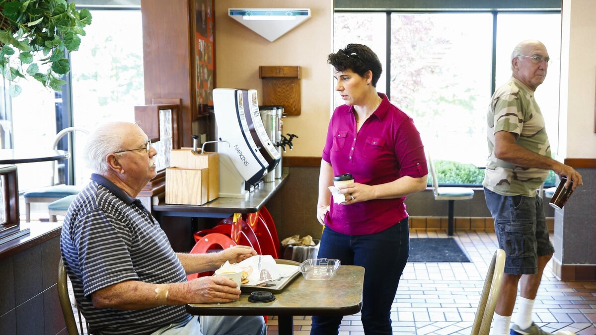 Chuck Roberts, of Versailles, left, spoke with Kentucky 6th Congressional District candidate Amy McGrath, center, at McDonalds while campaigning Monday in Versailles.
