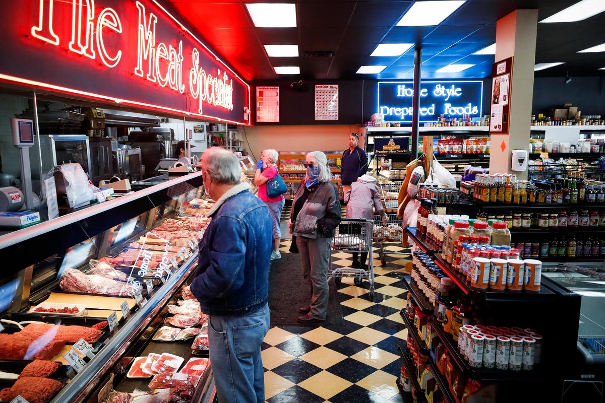Customers line up at the butcher’s counter at Critchfield Meats Friday.