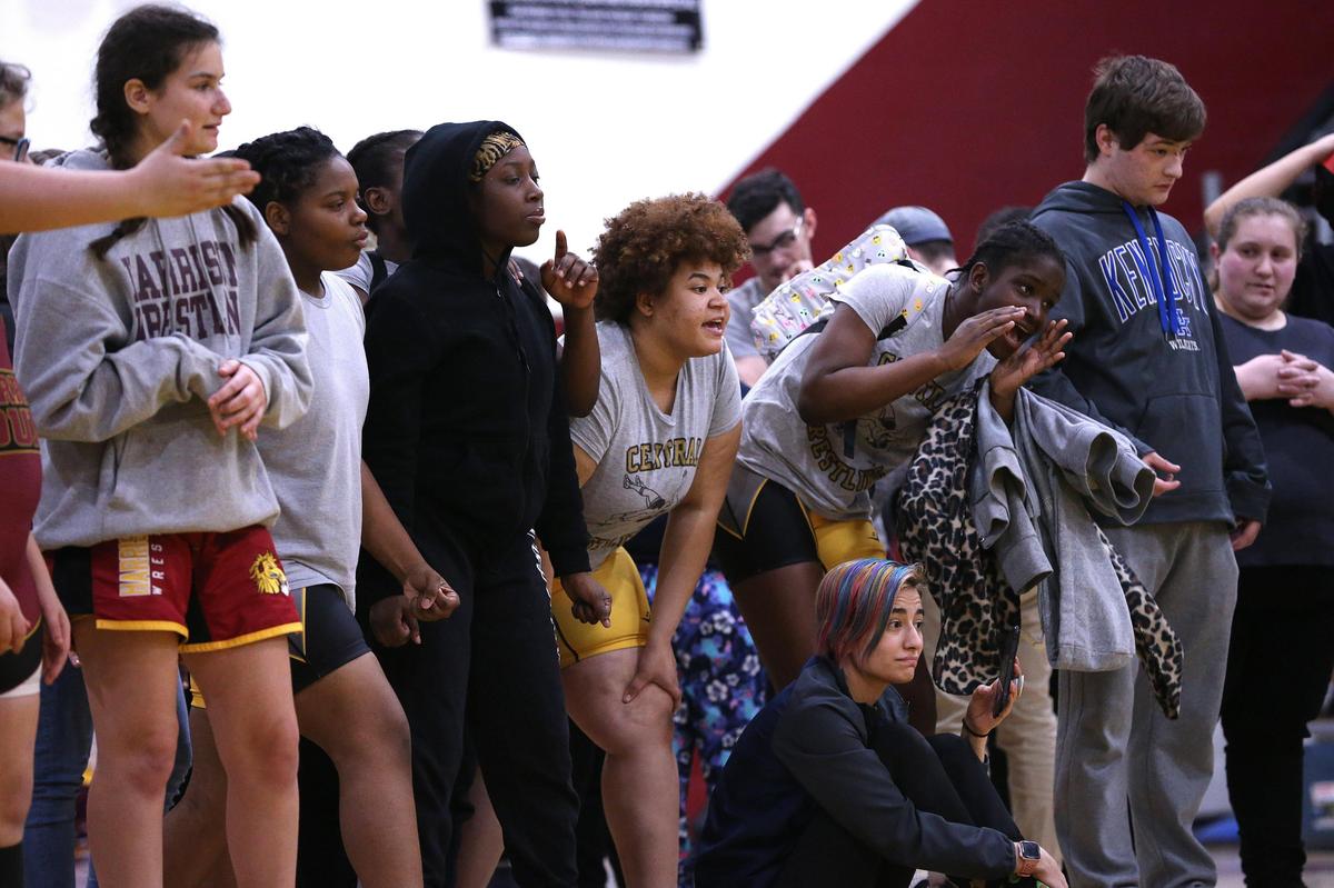 Wrestlers from Central High School cheered during a match featuring competitors from rival schools in Tates Creek’s Victoria Ndeemya and Harrison County’s Layla Davis during Saturday’s state championships. “It’s amazing how excited the girls are to compete,” said Union County Coach Robert Ervin.
