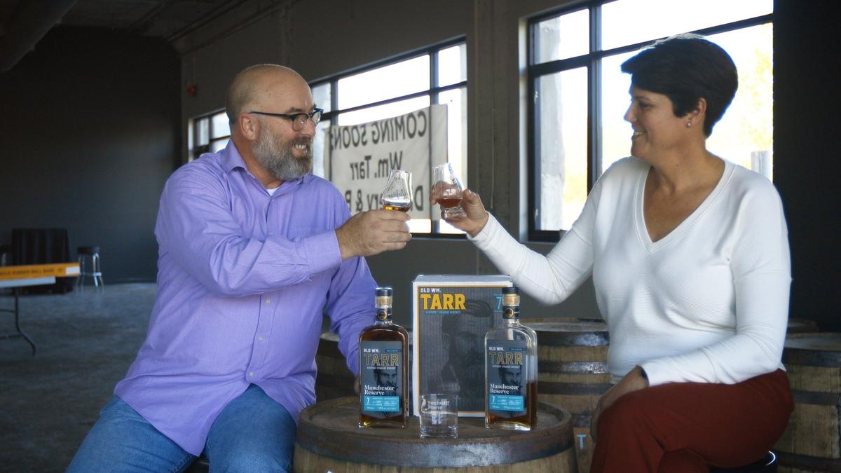 Wm. Tarr Distillery co-owners Barry Brinegar, left, and Jill Bakehorn, right, share a glass of Old Wm. Tarr Manchester Reserve Monday in celebration of the projected 2021 opening of the business in 2021 inside the Pepper Rickhouse building on Manchester street.