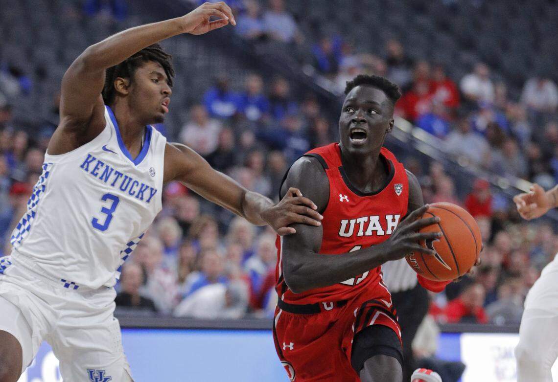 Utah’s Both Gach (11) drove around Kentucky’s Tyrese Maxey (3) during the first half in Las Vegas on Wednesday night.