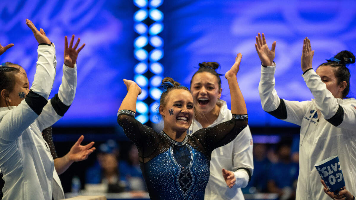 Raena Worley celebrates after scoring a 9.95 on beam in Kentucky’s win against LSU on Excite Night at Rupp Arena.