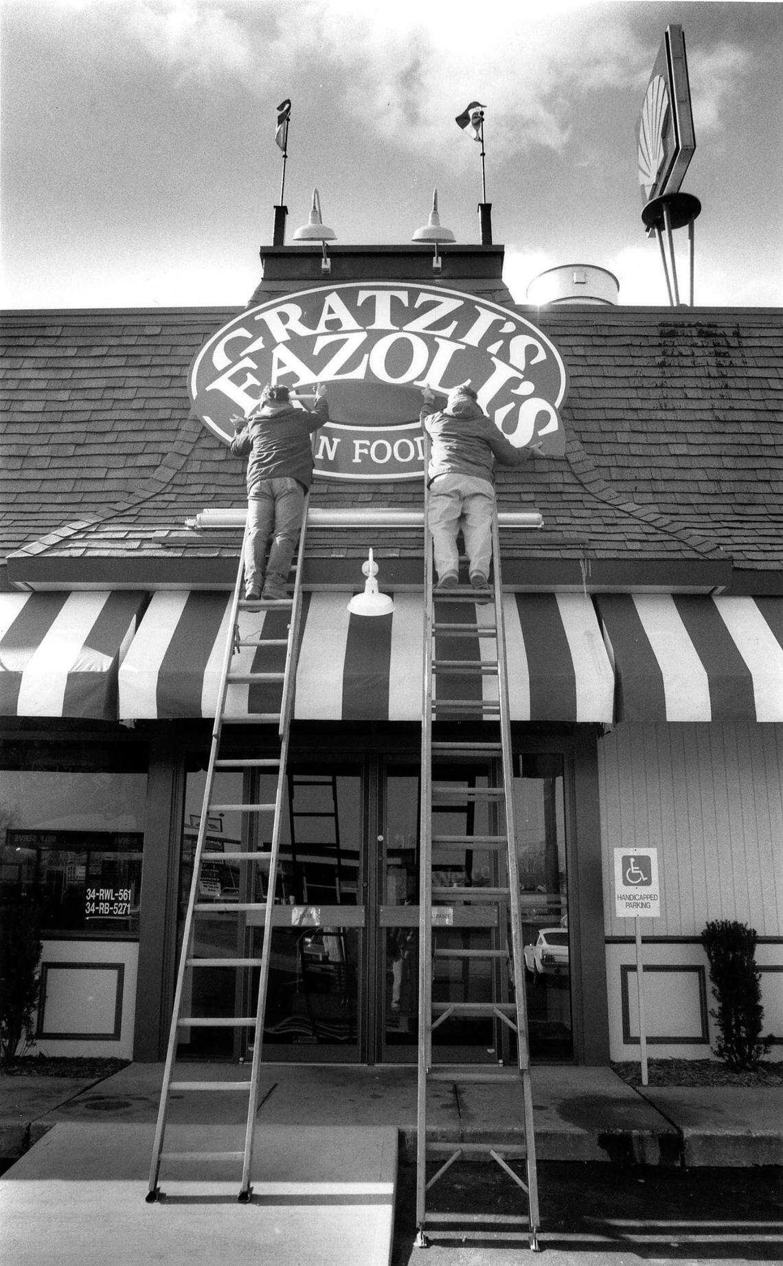 Martin Sherrod, left and Clint Sherrod of the Sherrod Sign Company change the sign on Gratzi’s, on North Broadway in Lexington, to it’s new name, Fazoli’s, February 10, 1989. The companies first Italian fast-food first restaurant on North Broadway near the Interstate 75-64 interchange, had been operated by Jerrico under the Gratzi’s name since September 1988. But surveys of potential customers showed that they kept confusing “Gratzi’s” - taken from the Italian word for “thank you” - with the name of Canadian-born hockey player Wayne Gretzky, said Robert L. Sirkis, Jerrico’s executive vice president. After hiring three naming firms and looking at tens of thousands of names, Jerrico decided to replace Gratzi’s with Fazoli’s. Which means . . . nothing. “It is completely made up,” Sirkis said. The company, still based in Lexington, currently operates 217 restaurants in 26 states.