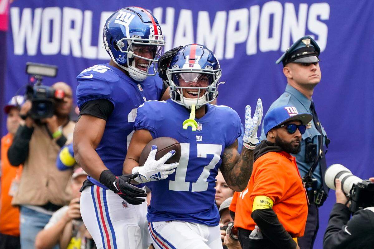 The New York Giants’ Wan’Dale Robinson (17) celebrates with teammate Saquon Barkley (26) after scoring the first touchdown of his NFL career against the Baltimore Ravens on Sunday in East Rutherford, N.J.