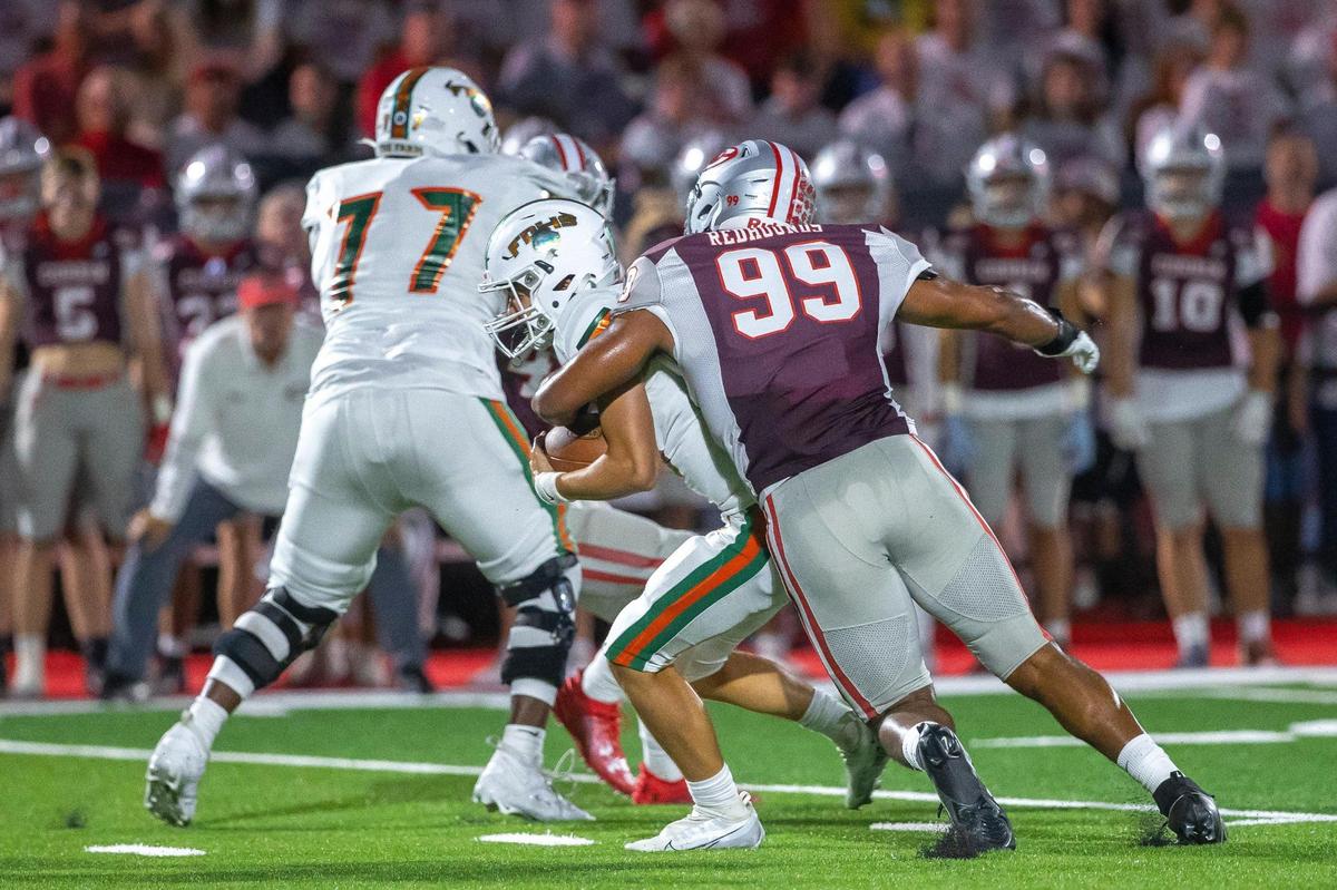 Corbin’s Jerod Smith (99) tackles Frederick Douglass quarterback Jaxon Strautman (14) on Friday night. Smith recorded four tackles, including two for loss, during the Redhounds’ win.