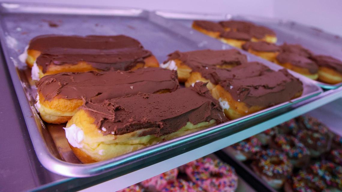 Chocolate iced cream filled long johns sit on a tray at Jeff’s Donuts, Thursday, Jan. 23, 2025, in Lexington, Ky. The Louisville-based doughnut shop has 22 varieties of long johns on its menu, which you can get filled or unfilled.