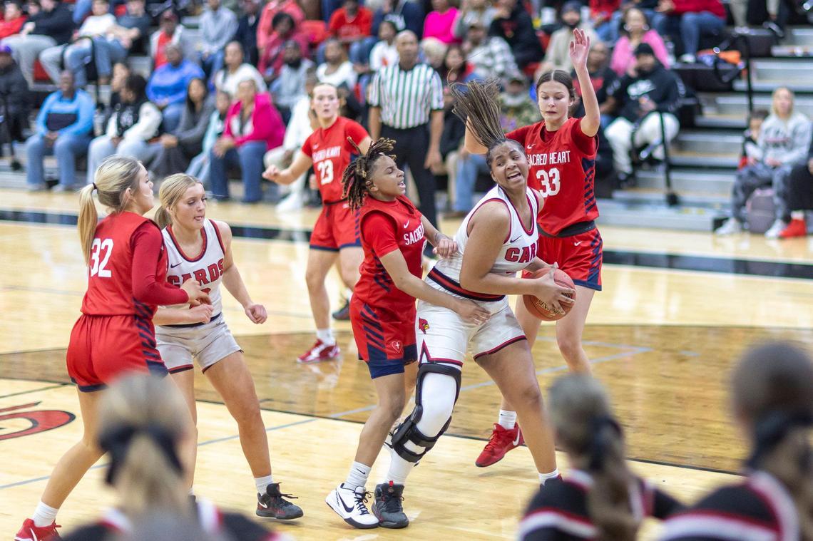 George Rogers Clark’s Ciara Byars (3) grabs a rebound in front of Sacred Heart’s Amirah Jordan (0) during their game in Winchester on Wednesday.
