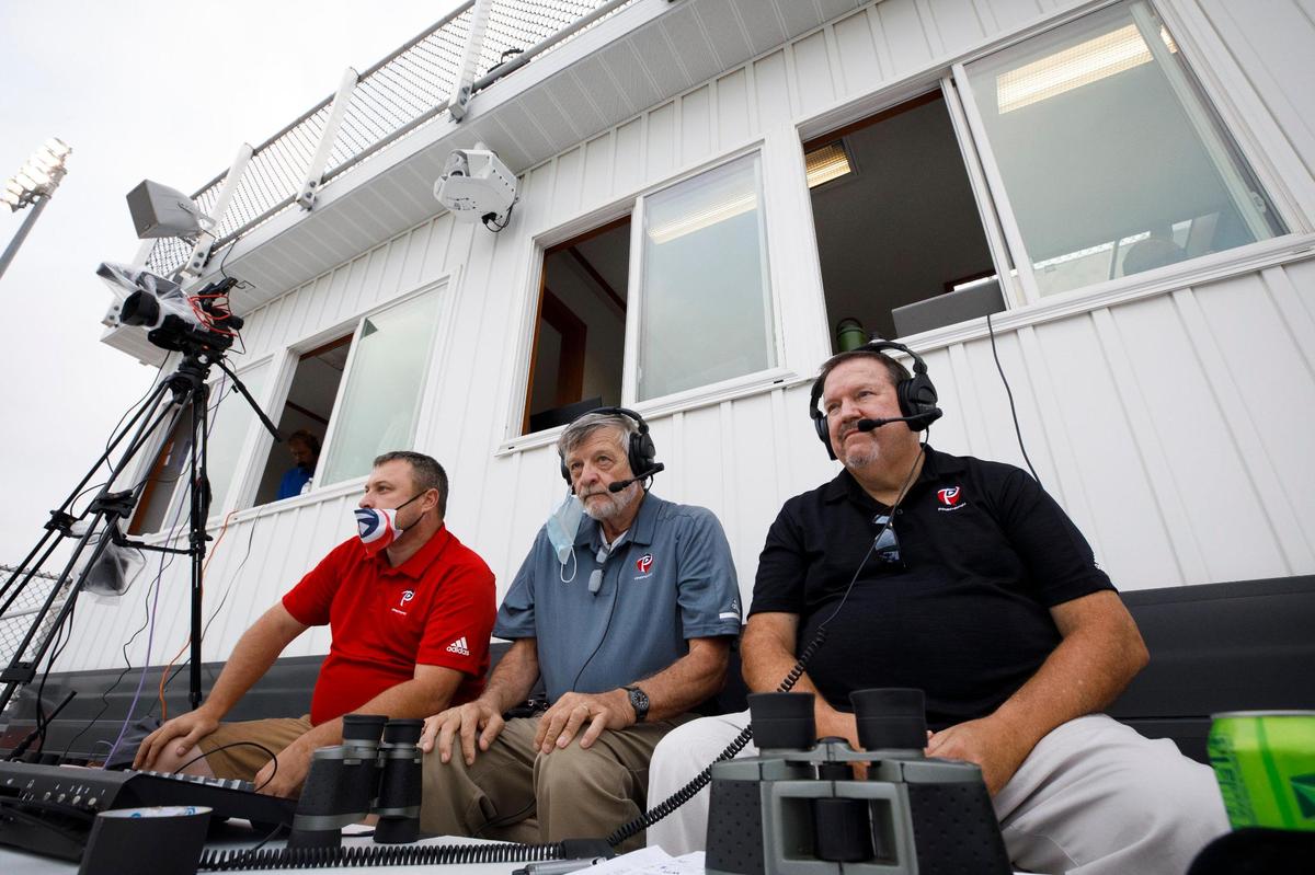 William Warfield, founder and owner of PrepSpin.com, from left, analyst Mike Meighan, and play-by-play commentator Gary Ball prepared for their broadcast of the Frederick Douglass-North Hardin football game on Sept. 11 at Frederick Douglass High School. The crew does a high school game of the week all season. Above them, at top, is Douglass’s new Pixellot camera that also streamed the game on the NFHS Network.