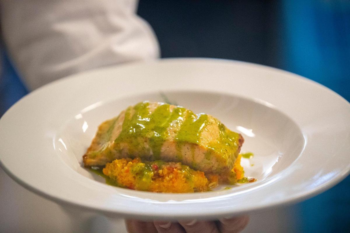 An entree of lemon dill salmon and vegetable couscous is served at the Lemon Tree in Erickson Hall on the University of Kentucky campus in Lexington, Ky., on Tuesday, Feb. 15, 2022.