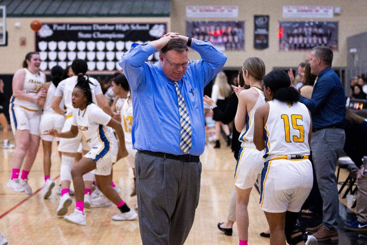 Franklin County head coach Joey Thacker begins to cry as his team celebrates its win against Frederick Douglass in the 11th Region finals at Paul Laurence Dunbar High School on Saturday.