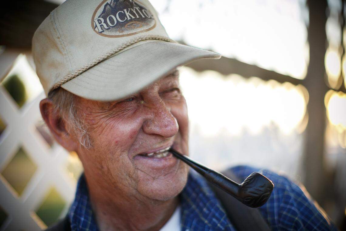 Buddy Hulett, of Lancaster, Ky., jokes with a friend while working a concession stand at the Garrard County Fair in Lancaster, Ky., Tuesday, June 25, 2019. Hulett has been cooking on a grill at the Garrard County Fair for over 20 years and invented the “Buddy Burger” which comes with nacho cheese and jalapeos.