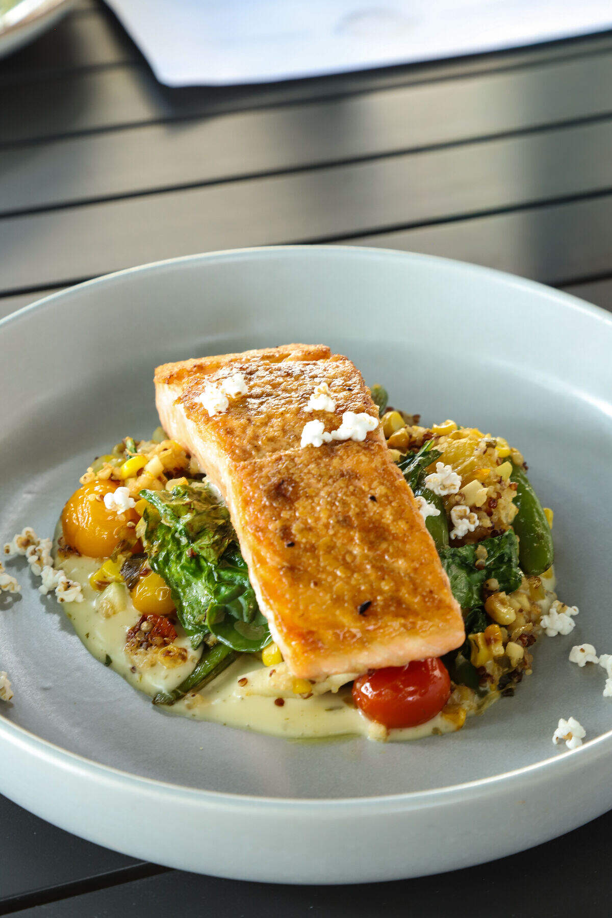 Millstone’s seared salmon with quinoa, sorghum, snap peas, charred corn, leeks, apple, cherry tomato and lemon tarragon vinaigrette ($41).