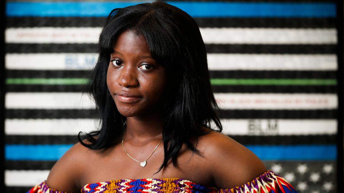 Lordina Mensah, of Lexington, Ky., poses for a portrait near artwork hanging in The Living Arts & Science Center in Lexington, Tuesday, Aug. 3, 2021.