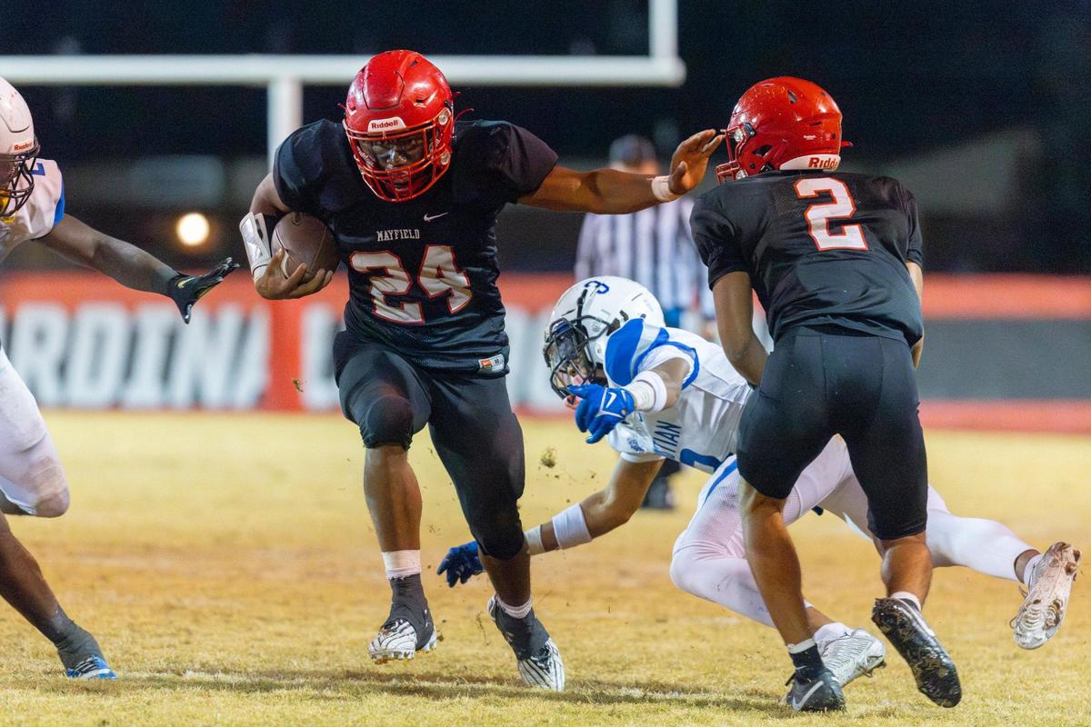 Mayfield’s Jutoriaus “JuJu’ Starks (24) runs the ball past LCA’s Braylon Moss (3) during Friday’s game at War Memorial Stadium in Mayfield. Starks ran for 171 yards and three touchdowns.