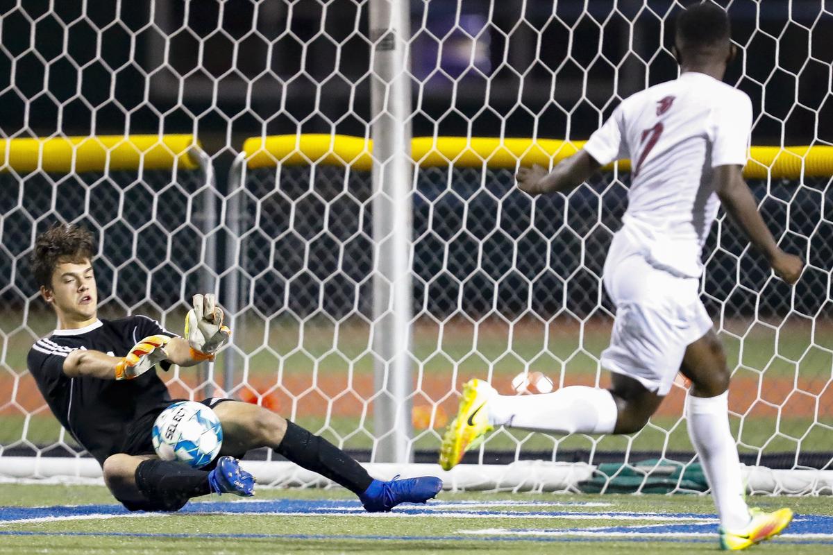 Paul Laurence Dunbar’s William Elliot (1) blocked a shot from Tates Creek’s Ben Kaindu (7) during the 43rd District soccer semifinals Wednesday at Lexington Catholic High School in Lexington. Paul Laurence Dunbar beat Tates Creek in a shootout.