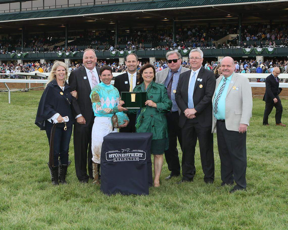 The connections of Stonestreet Lexington winner My Boy Jack, including jockey Kent Desormeaux and Don't Tell My Wife Stables partner Kirk Godby, second from right, celebrated with the trophy on the turf course at Keeneland on April 14.